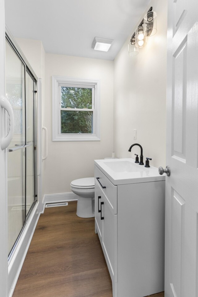222 Jackson St, Lawrenceburg, TN 38464 - full bath with vanity, a shower with shower door, and wood finished floors