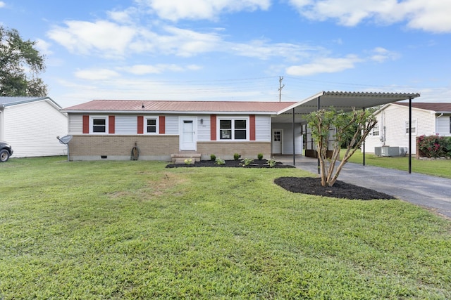 222 Jackson St, Lawrenceburg, TN 38464 - single story home featuring driveway, entry steps, brick siding, a front lawn, and a carport