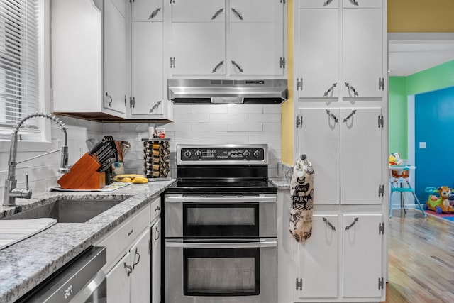 314 W 2nd St, Jasper, TN 37347 - kitchen featuring under cabinet range hood, stainless steel appliances, white cabinets, and backsplash