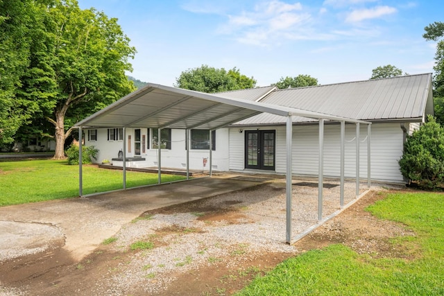314 W 2nd St, Jasper, TN 37347 - single story home with french doors, a front yard, driveway, and a metal roof