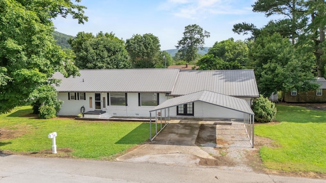 314 W 2nd St, Jasper, TN 37347 - view of front facade featuring driveway, a front lawn, and a metal roof