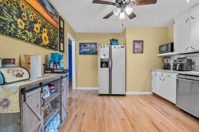 314 W 2nd St, Jasper, TN 37347 - kitchen with fridge with ice dispenser, stainless steel dishwasher, black microwave, light wood finished floors, and white cabinetry