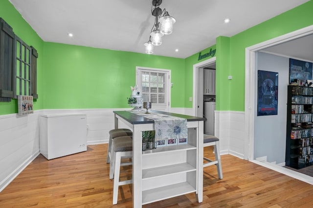 314 W 2nd St, Jasper, TN 37347 - kitchen featuring a wainscoted wall, wood finished floors, refrigerator, and pendant lighting