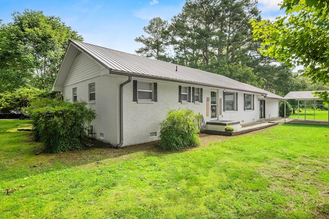 314 W 2nd St, Jasper, TN 37347 - back of house with brick siding, a metal roof, a yard, crawl space, and a standing seam roof