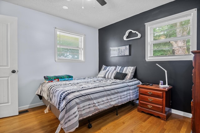 314 W 2nd St, Jasper, TN 37347 - bedroom featuring wood finished floors, a textured ceiling, and a ceiling fan