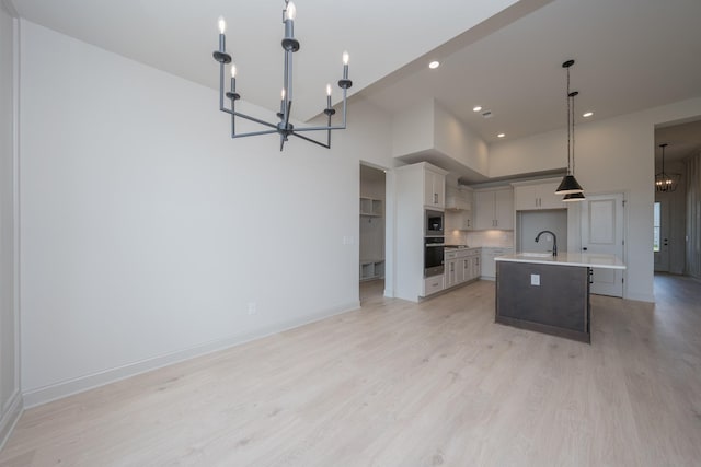 5416 Bridgemore Blvd, Murfreesboro, TN 37129 - kitchen with a chandelier, light countertops, light wood-type flooring, recessed lighting, and an island with sink