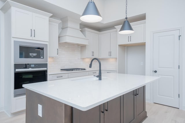 5416 Bridgemore Blvd, Murfreesboro, TN 37129 - kitchen featuring appliances with stainless steel finishes, decorative backsplash, white cabinets, light wood-style flooring, and light countertops