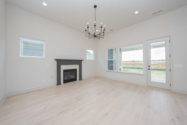 5416 Bridgemore Blvd, Murfreesboro, TN 37129 - unfurnished living room with light wood-style floors, a glass covered fireplace, a chandelier, and recessed lighting