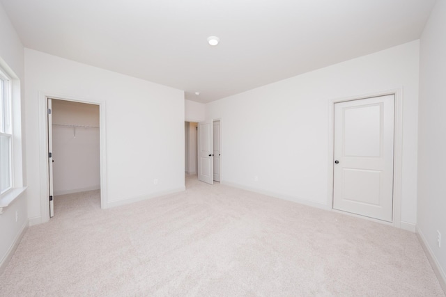 5416 Bridgemore Blvd, Murfreesboro, TN 37129 - unfurnished bedroom featuring light colored carpet, a walk in closet, and a closet