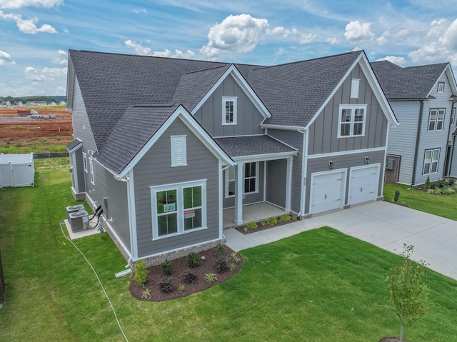 5416 Bridgemore Blvd, Murfreesboro, TN 37129 - view of front of home with board and batten siding, driveway, an attached garage, a front lawn, and roof with shingles