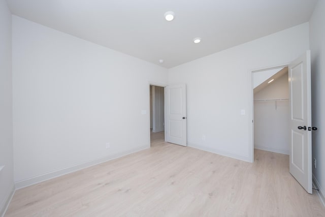 5416 Bridgemore Blvd, Murfreesboro, TN 37129 - unfurnished bedroom with light wood-style flooring, a walk in closet, and a closet