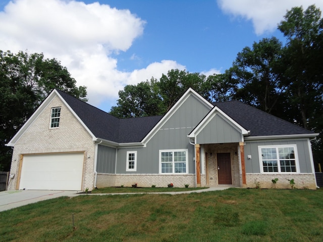 517 Oak Timber Pl, Antioch, TN 37013 - view of front facade with brick siding, board and batten siding, a front lawn, concrete driveway, and roof with shingles