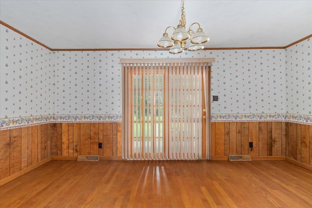 718 Midway St, Lewisburg, TN 37091 - unfurnished dining area featuring a chandelier, wallpapered walls, wood finished floors, crown molding, and wainscoting