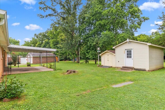 718 Midway St, Lewisburg, TN 37091 - view of grassy yard featuring a shed and a detached carport
