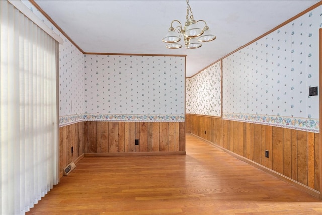 718 Midway St, Lewisburg, TN 37091 - unfurnished room featuring wallpapered walls, ornamental molding, wood finished floors, a chandelier, and a wainscoted wall