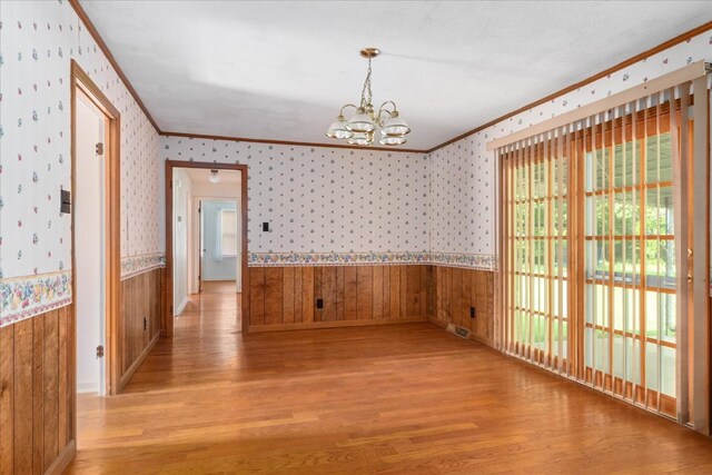 718 Midway St, Lewisburg, TN 37091 - unfurnished dining area featuring ornamental molding, wood finished floors, a chandelier, a wainscoted wall, and wallpapered walls