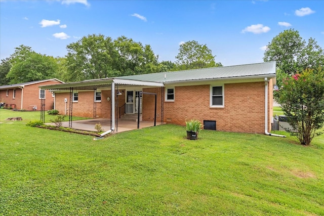 718 Midway St, Lewisburg, TN 37091 - rear view of property featuring a patio, brick siding, a yard, and a metal roof