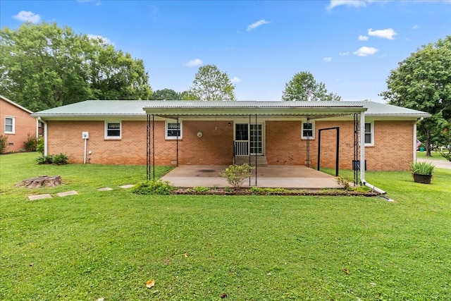 718 Midway St, Lewisburg, TN 37091 - rear view of house featuring a patio area, a lawn, brick siding, and a metal roof