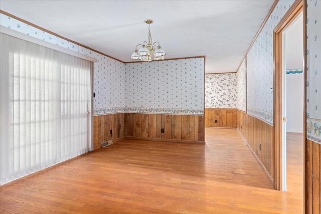 718 Midway St, Lewisburg, TN 37091 - unfurnished dining area with light wood finished floors, a chandelier, a wainscoted wall, crown molding, and wallpapered walls
