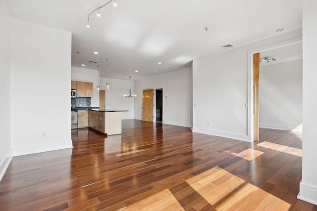 2201 8th Ave S Unit 306, Nashville, TN 37204 - unfurnished living room with a chandelier, dark wood-style floors, and recessed lighting