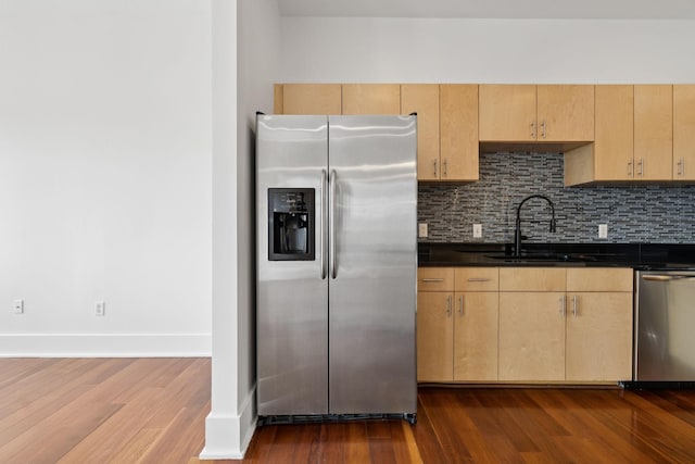 2201 8th Ave S Unit 306, Nashville, TN 37204 - kitchen featuring appliances with stainless steel finishes, light brown cabinetry, and dark countertops