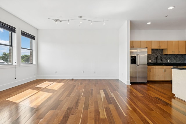 2201 8th Ave S Unit 306, Nashville, TN 37204 - kitchen featuring stainless steel refrigerator with ice dispenser, light brown cabinetry, dark wood-style floors, tasteful backsplash, and dark countertops