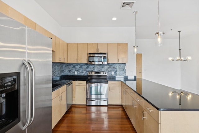 2201 8th Ave S Unit 306, Nashville, TN 37204 - kitchen with stainless steel appliances, light brown cabinets, a peninsula, tasteful backsplash, and dark wood finished floors
