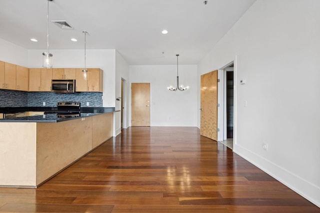 2201 8th Ave S Unit 306, Nashville, TN 37204 - kitchen featuring stainless steel appliances, light brown cabinetry, a chandelier, dark countertops, and dark wood-type flooring