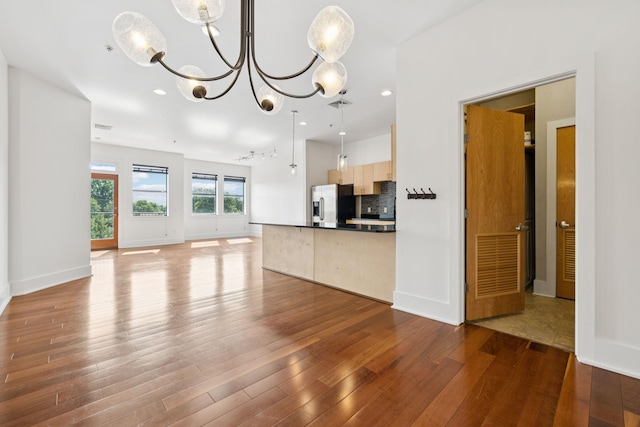2201 8th Ave S Unit 306, Nashville, TN 37204 - unfurnished living room with wood finished floors, a chandelier, and recessed lighting