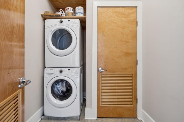 2201 8th Ave S Unit 306, Nashville, TN 37204 - washroom featuring stacked washer / drying machine and baseboards