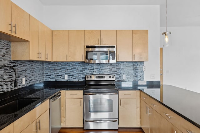 2201 8th Ave S Unit 306, Nashville, TN 37204 - kitchen with stainless steel appliances, light brown cabinets, backsplash, and dark stone countertops