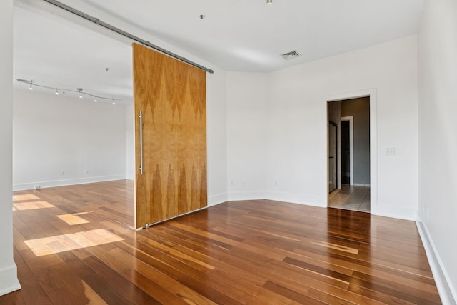 2201 8th Ave S Unit 306, Nashville, TN 37204 - unfurnished room with wood-type flooring and baseboards