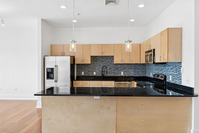 2201 8th Ave S Unit 306, Nashville, TN 37204 - kitchen with stainless steel appliances, light brown cabinetry, light wood-style floors, decorative backsplash, and recessed lighting