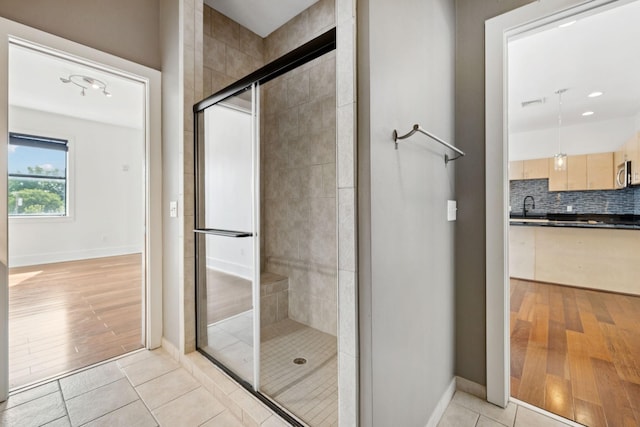 2201 8th Ave S Unit 306, Nashville, TN 37204 - full bathroom with a stall shower, wood finished floors, decorative backsplash, and recessed lighting