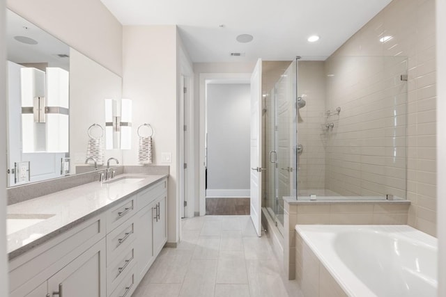 20 Rutledge St Unit 407, Nashville, TN 37210 - bathroom featuring a shower stall, double vanity, a bath, recessed lighting, and tile patterned floors