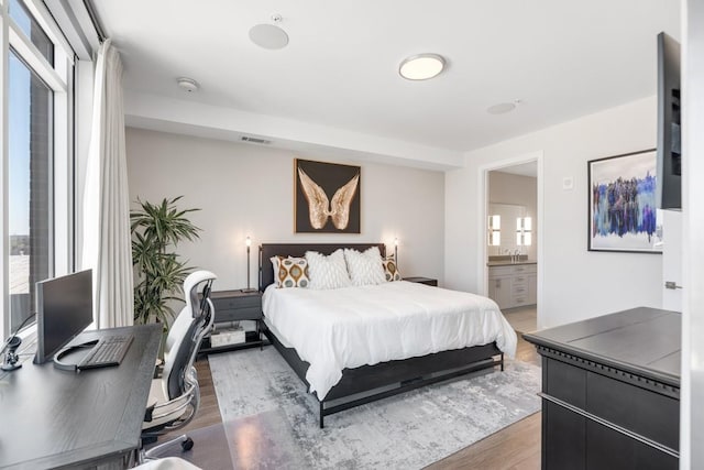 20 Rutledge St Unit 407, Nashville, TN 37210 - bedroom featuring light wood-style floors, ensuite bathroom, and an office area