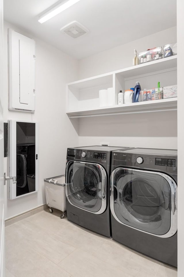 20 Rutledge St Unit 407, Nashville, TN 37210 - washroom featuring separate washer and dryer and light tile patterned floors