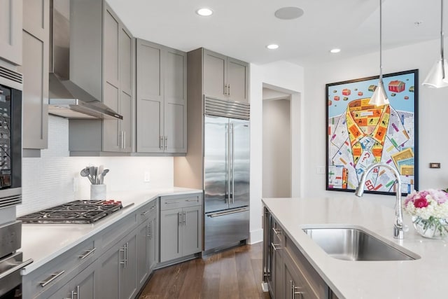 20 Rutledge St Unit 407, Nashville, TN 37210 - kitchen with stainless steel appliances, wall chimney range hood, gray cabinets, light countertops, and dark wood-type flooring