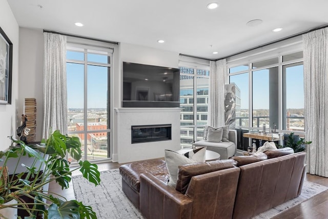 20 Rutledge St Unit 407, Nashville, TN 37210 - living room with a glass covered fireplace, wood finished floors, plenty of natural light, and recessed lighting