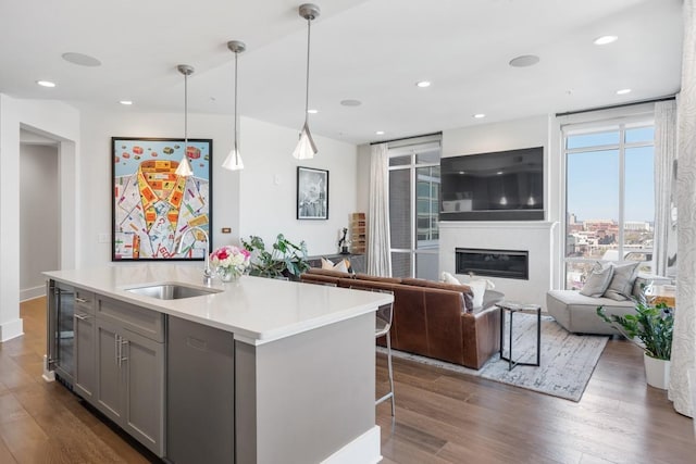 20 Rutledge St Unit 407, Nashville, TN 37210 - kitchen featuring gray cabinetry, dishwasher, wine cooler, light countertops, and dark wood finished floors