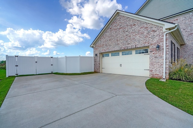824 Promise Way, Murfreesboro, TN 37128 - view of side of home featuring concrete driveway, a gate, brick siding, and an attached garage