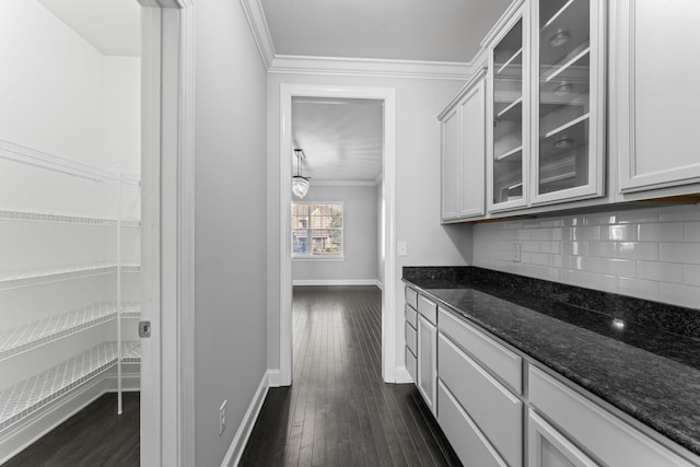 824 Promise Way, Murfreesboro, TN 37128 - kitchen with ornamental molding, decorative backsplash, glass insert cabinets, dark stone counters, and dark wood finished floors