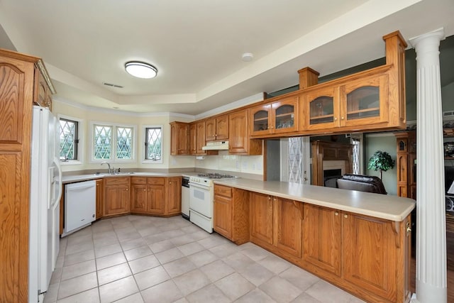 27615 Shannon Rd, Ardmore, AL 35739 - kitchen featuring white appliances, a peninsula, brown cabinetry, glass insert cabinets, and light countertops