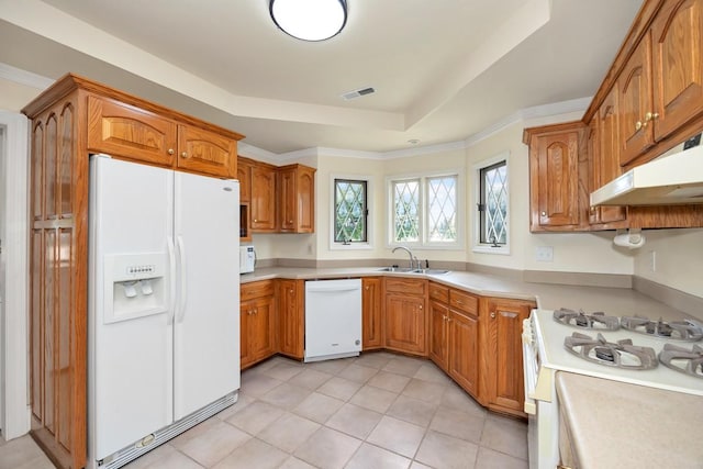 27615 Shannon Rd, Ardmore, AL 35739 - kitchen featuring white appliances, under cabinet range hood, a raised ceiling, and brown cabinetry