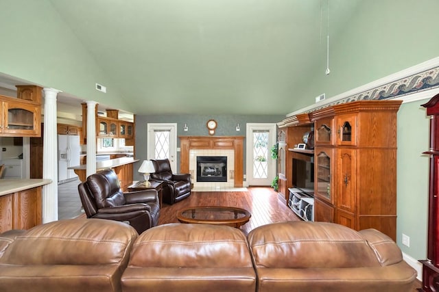 27615 Shannon Rd, Ardmore, AL 35739 - living room featuring high vaulted ceiling, a tile fireplace, and wood finished floors