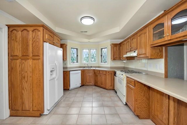 27615 Shannon Rd, Ardmore, AL 35739 - kitchen featuring white appliances, under cabinet range hood, brown cabinetry, a raised ceiling, and glass insert cabinets