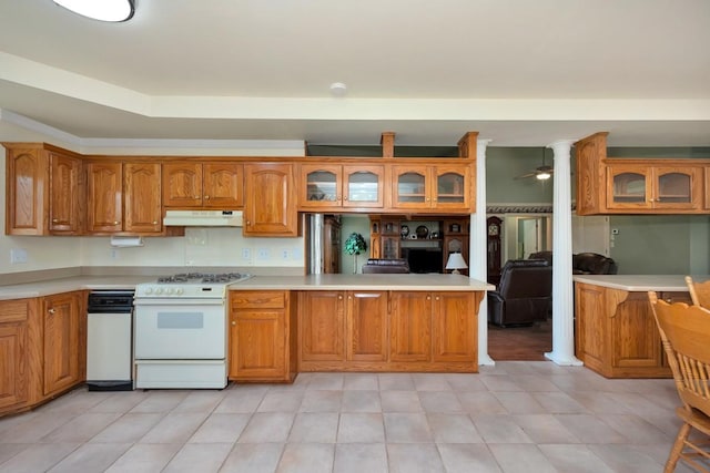 27615 Shannon Rd, Ardmore, AL 35739 - kitchen featuring white range with gas stovetop, under cabinet range hood, glass insert cabinets, brown cabinets, and light countertops