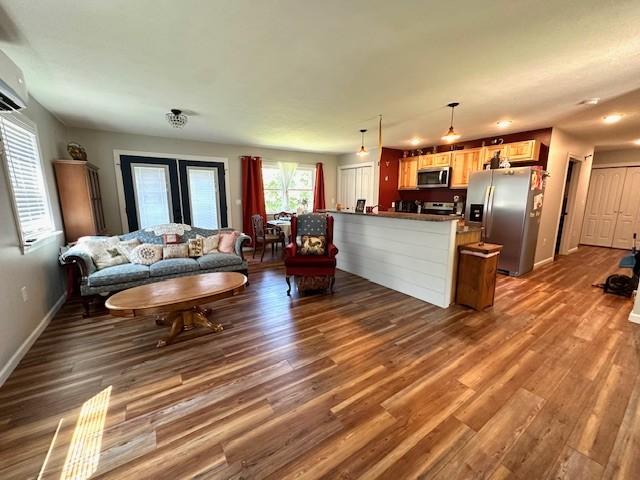 2082 Airport Ridge Rd, Linden, TN 37096 - living room with dark wood-style floors and a wall unit AC