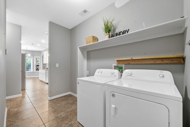 1398 Raven Rd, Clarksville, TN 37042 - laundry room featuring washer and clothes dryer and light tile patterned floors