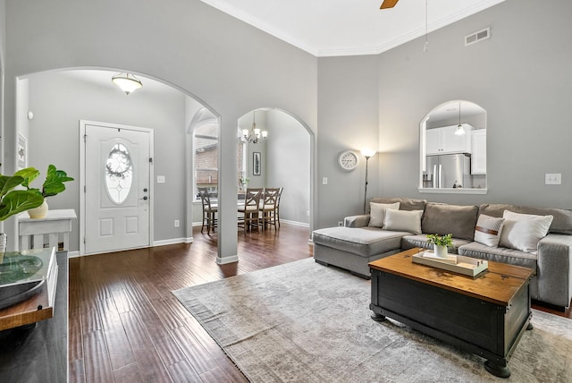 1398 Raven Rd, Clarksville, TN 37042 - living room featuring arched walkways, a towering ceiling, wood finished floors, ornamental molding, and ceiling fan